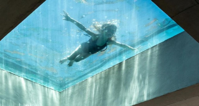 This gorgeous Sao Paulo penthouse has an all-glass rooftop swimming pool that filters sunlight indoors